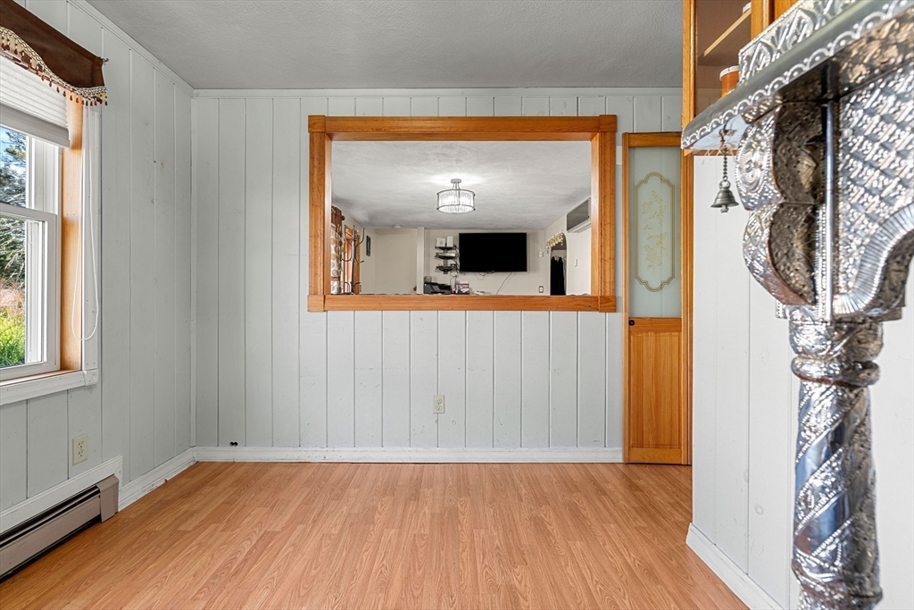 3 Stone Court Gloucester, MA 01930 - Photo 12 of 28 a view of an empty room with wooden floor and a window