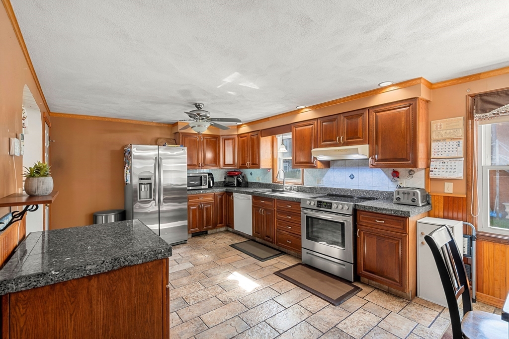 3 Stone Court Gloucester, MA 01930 - Photo 4 of 28 a kitchen with stainless steel appliances granite countertop a stove a sink dishwasher and a refrigerator