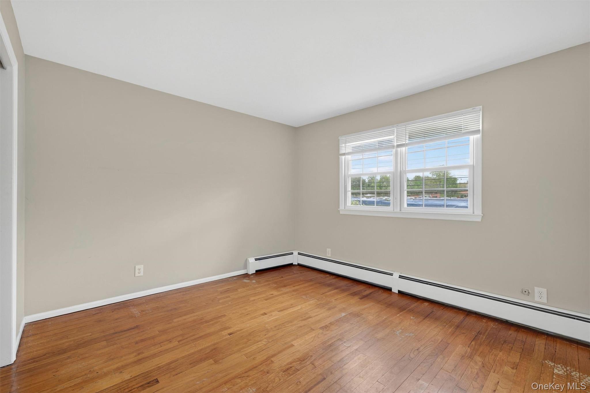 155 Pine Tree Road Monroe, NY 10950 - Photo 25 of 49 an empty room with a wooden floor and windows