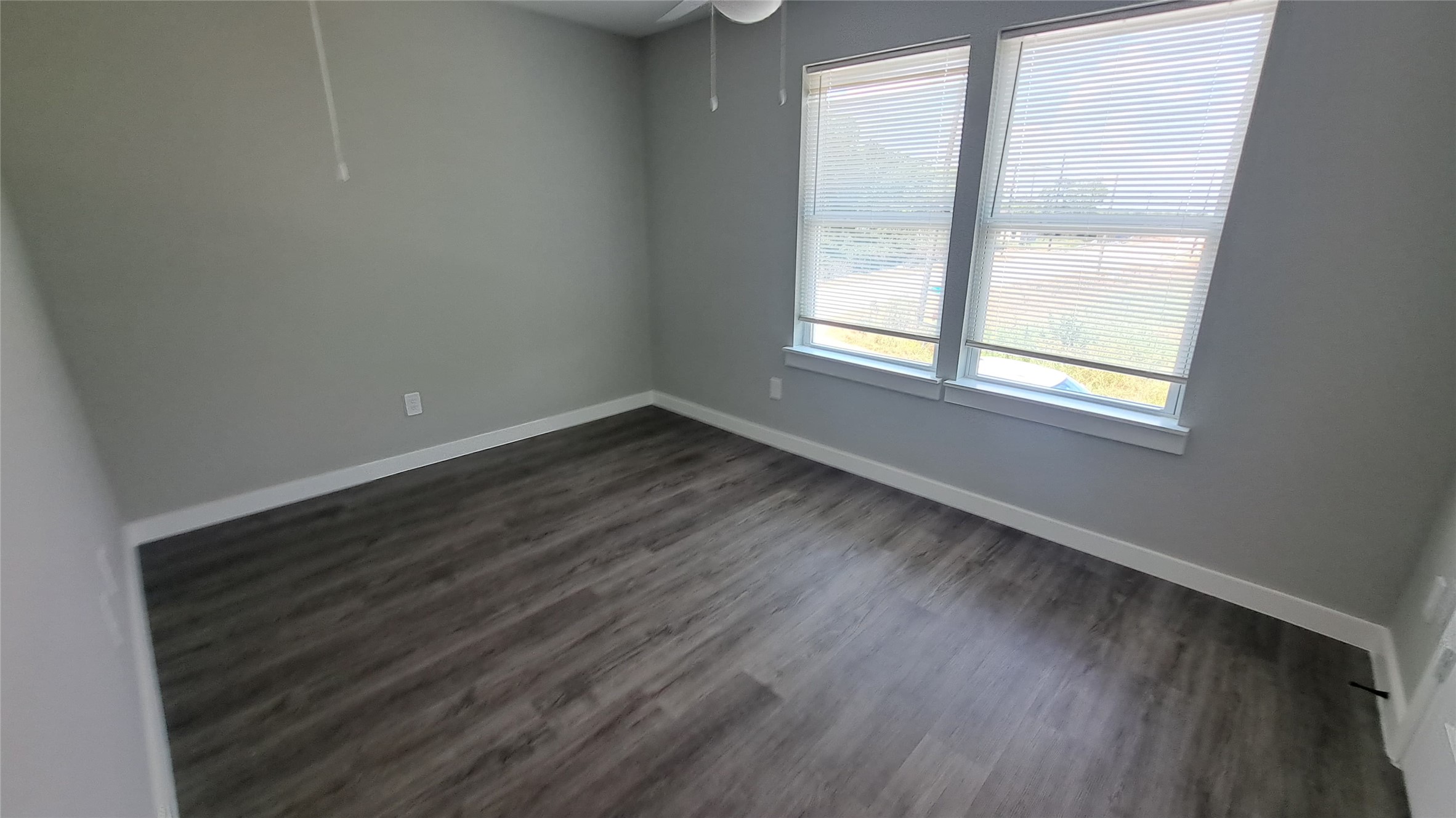 9806 Fillmore Street, Unit B Houston, TX 77029 - Photo 9 of 9 an empty room with wooden floor and windows
