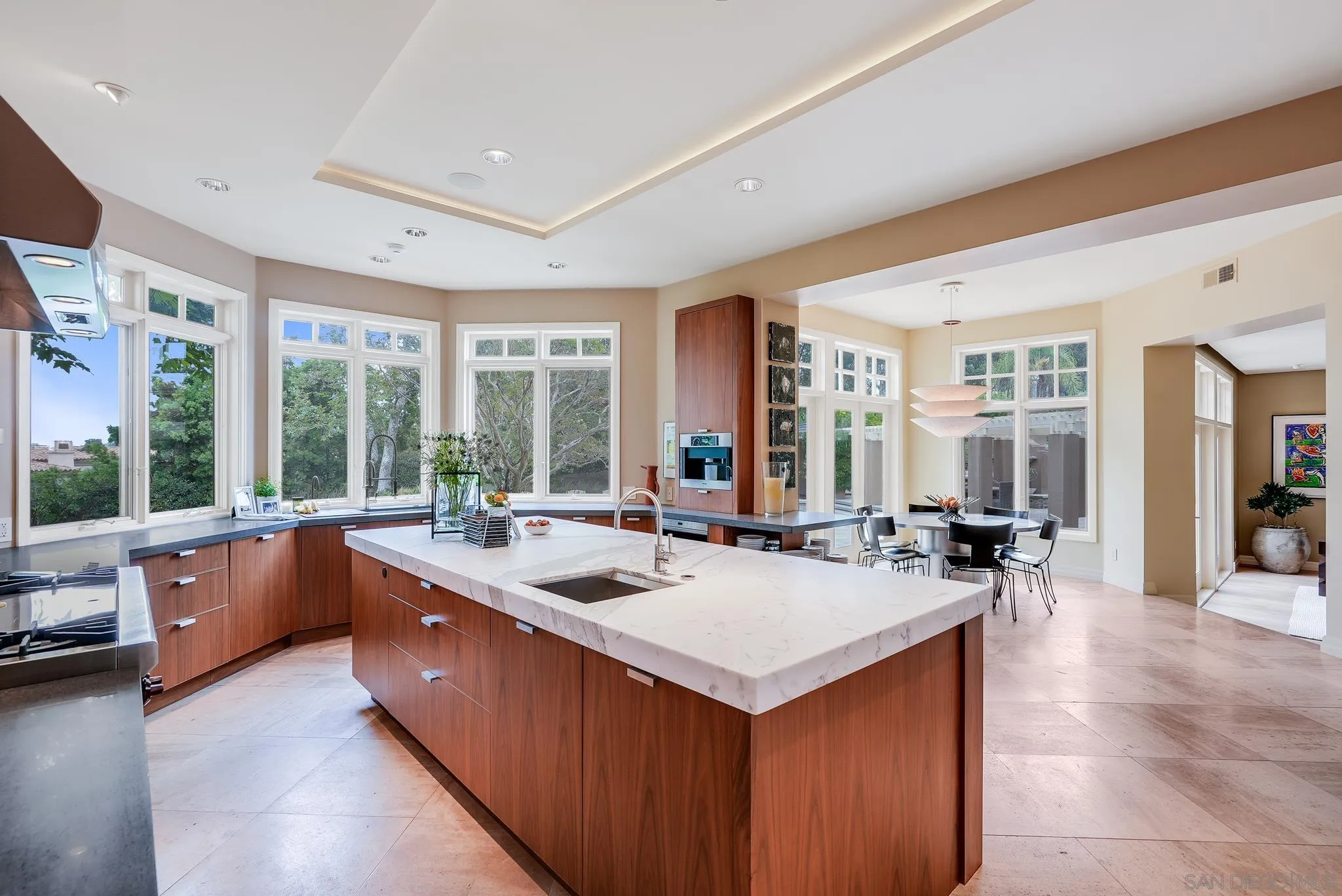 7891 Muirfield Way Rancho Santa Fe, CA 92067 - Photo 18 of 47 a large white kitchen with a large window and table