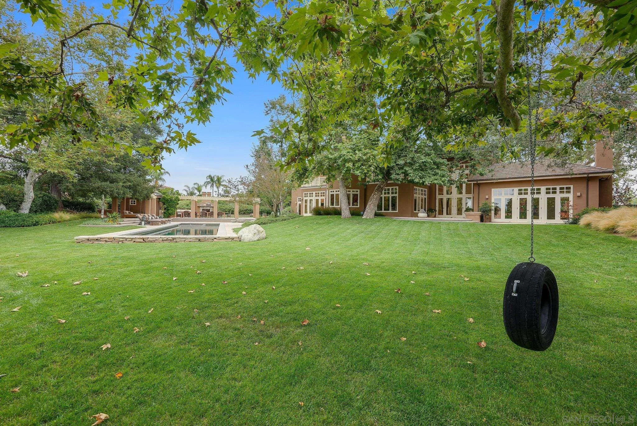 7891 Muirfield Way Rancho Santa Fe, CA 92067 - Photo 2 of 47 a view of a house with a backyard