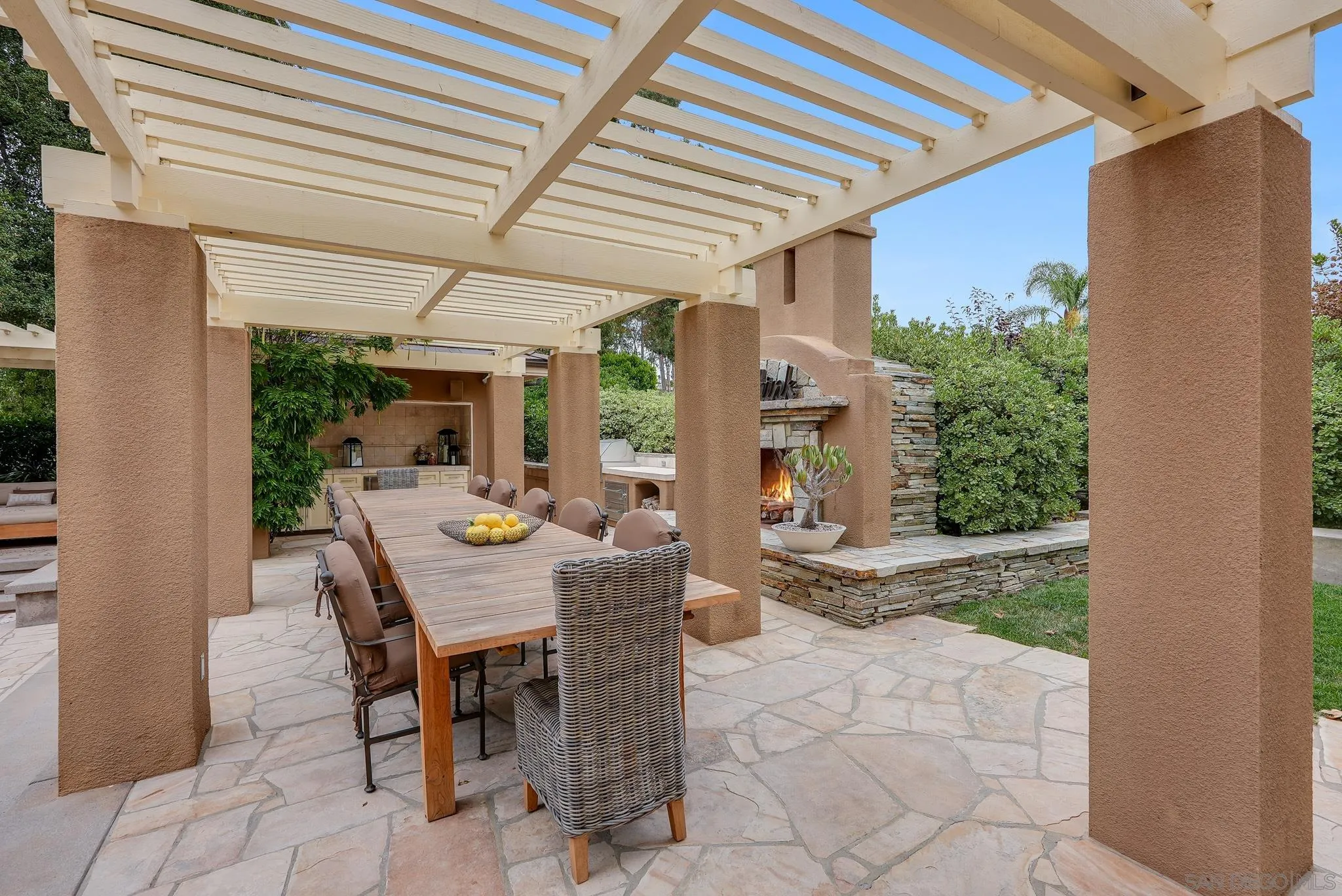 7891 Muirfield Way Rancho Santa Fe, CA 92067 - Photo 43 of 47 a view of a patio with table and chairs and potted plants