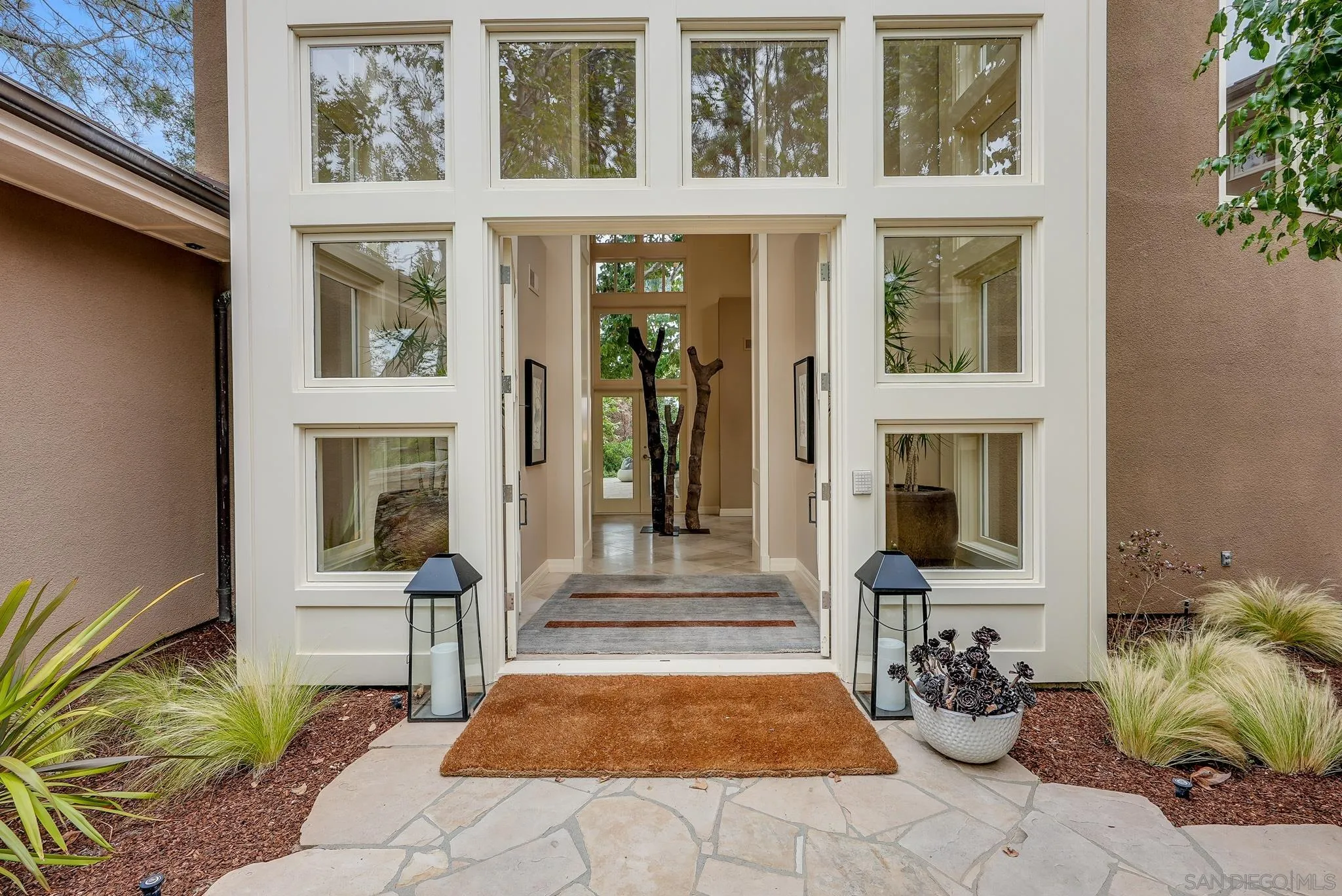 7891 Muirfield Way Rancho Santa Fe, CA 92067 - Photo 7 of 47 a front view of a house with outdoor seating