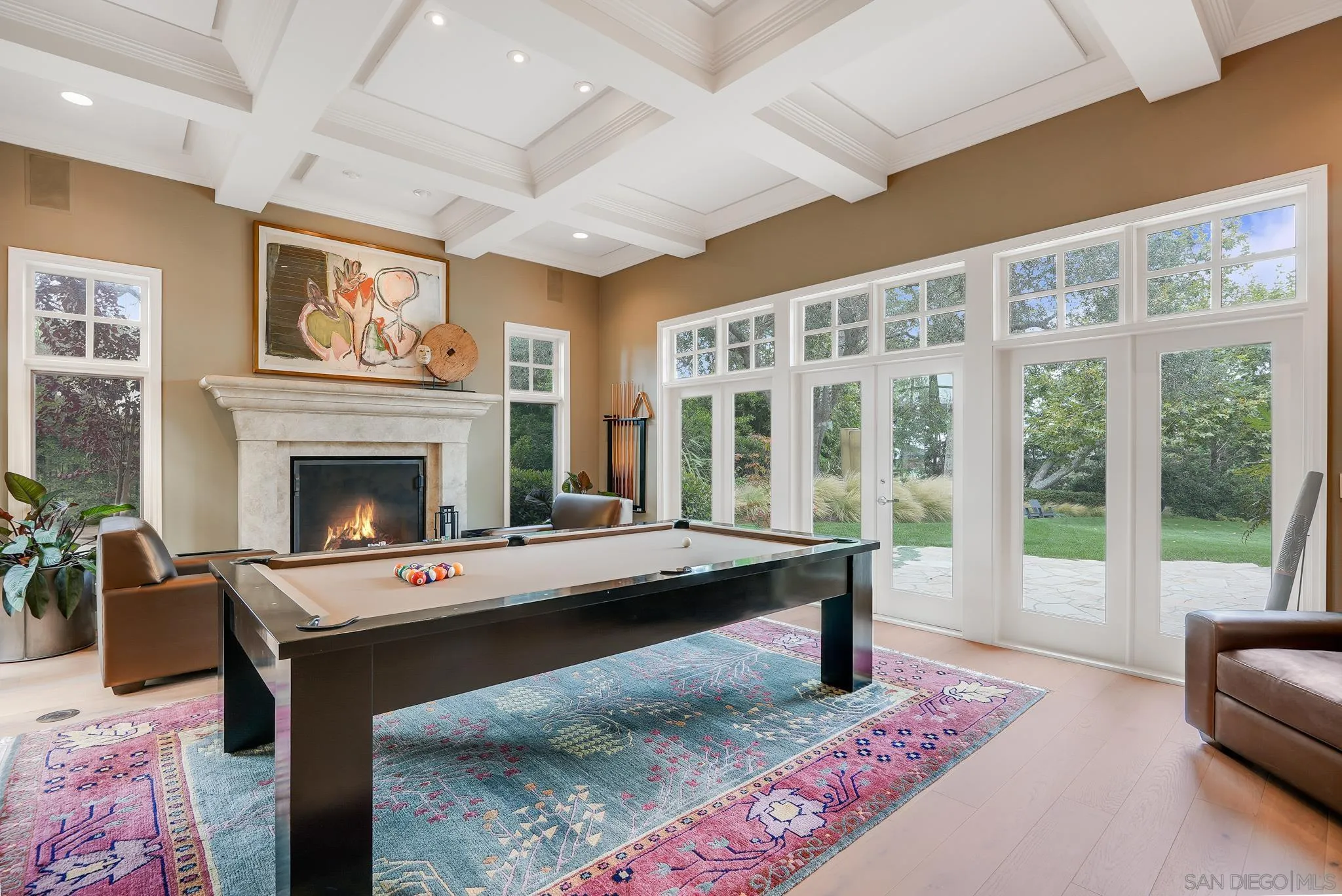 7891 Muirfield Way Rancho Santa Fe, CA 92067 - Photo 9 of 47 a living room with furniture a table and a fireplace