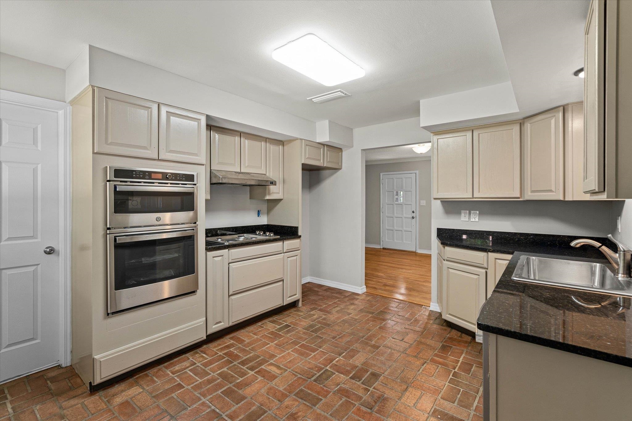 4700 Bit And Spur Road Mobile, AL 36608 - Photo 8 of 21 Kitchen featuring a sink, baseboards, under cabinet range hood, cooktop, and double oven