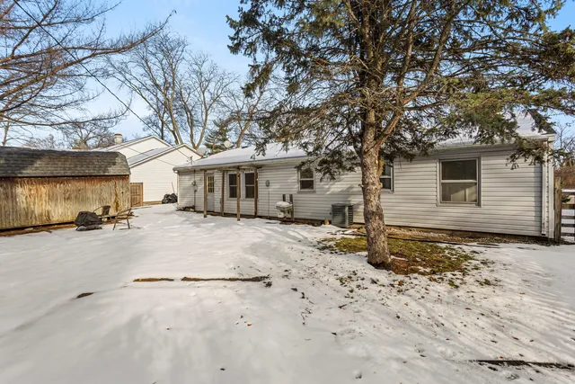 a backyard of a house with table and chairs