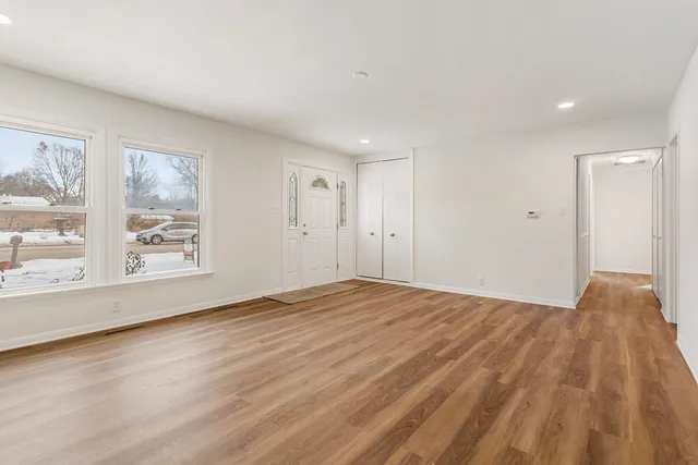 a view of a kitchen with a stove wooden floor and a window