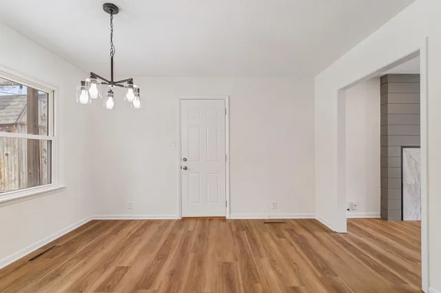 a kitchen with cabinets appliances a sink and a window