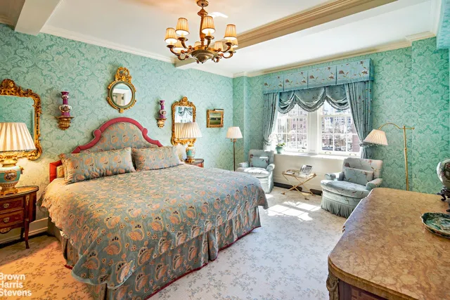 a bedroom with bed and a chandelier