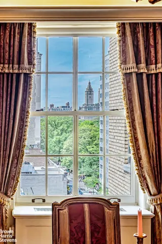 a view of a balcony with wooden floor and fence