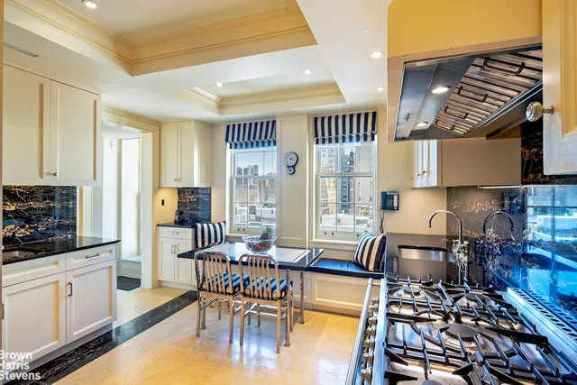 a kitchen with a table chairs stove and cabinets