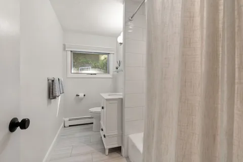 a bathroom with a toilet and a shower