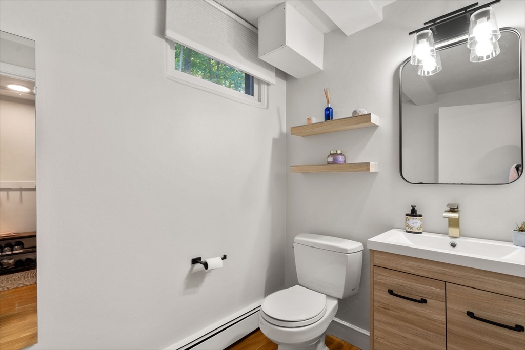 28 Woodbine Circle Needham, MA 02494 - Photo 24 of 29 a bathroom with a sink vanity mirror and toilet