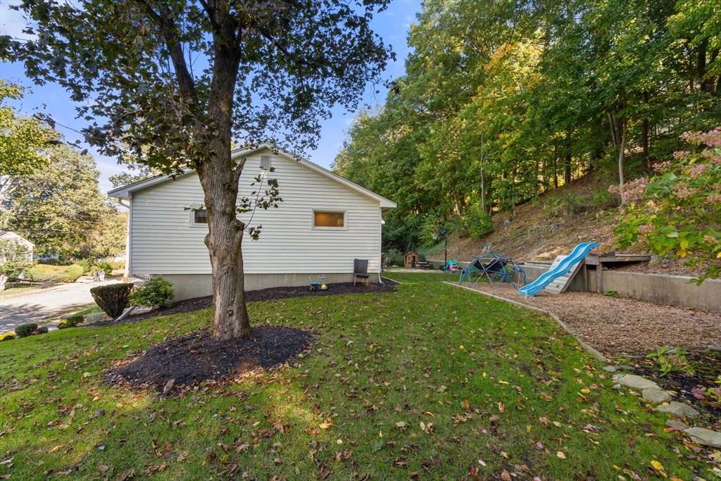 28 Woodbine Circle Needham, MA 02494 - Photo 27 of 29 a house is sitting in middle od the grass