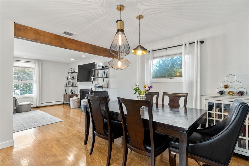 28 Woodbine Circle Needham, MA 02494 - Photo 10 of 29 a view of a dining room and livingroom with furniture wooden floor a chandelier