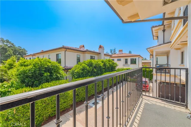 a view of a room with wooden floor kitchen view and a chandelier