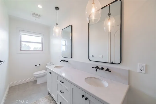a bathroom with a sink vanity granite shower and a mirror