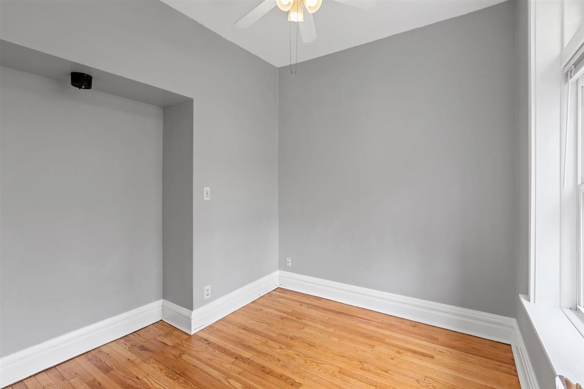 3716 North Wayne Avenue, Unit 2 Chicago, IL 60613 - Photo 12 of 17 a view of empty room with wooden floor and fan
