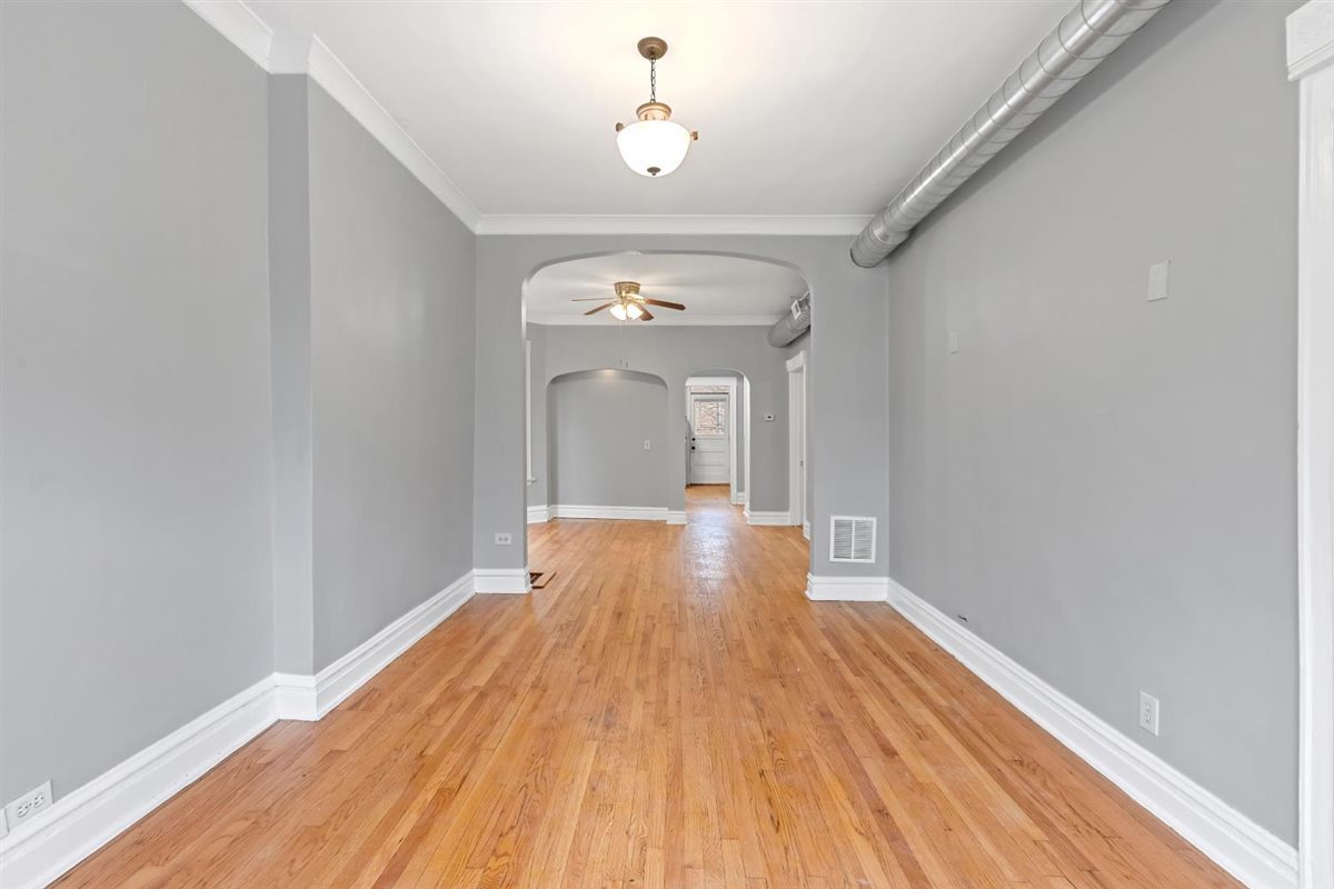 3716 North Wayne Avenue, Unit 2 Chicago, IL 60613 - Photo 13 of 17 a view of a room with wooden floor fan and window