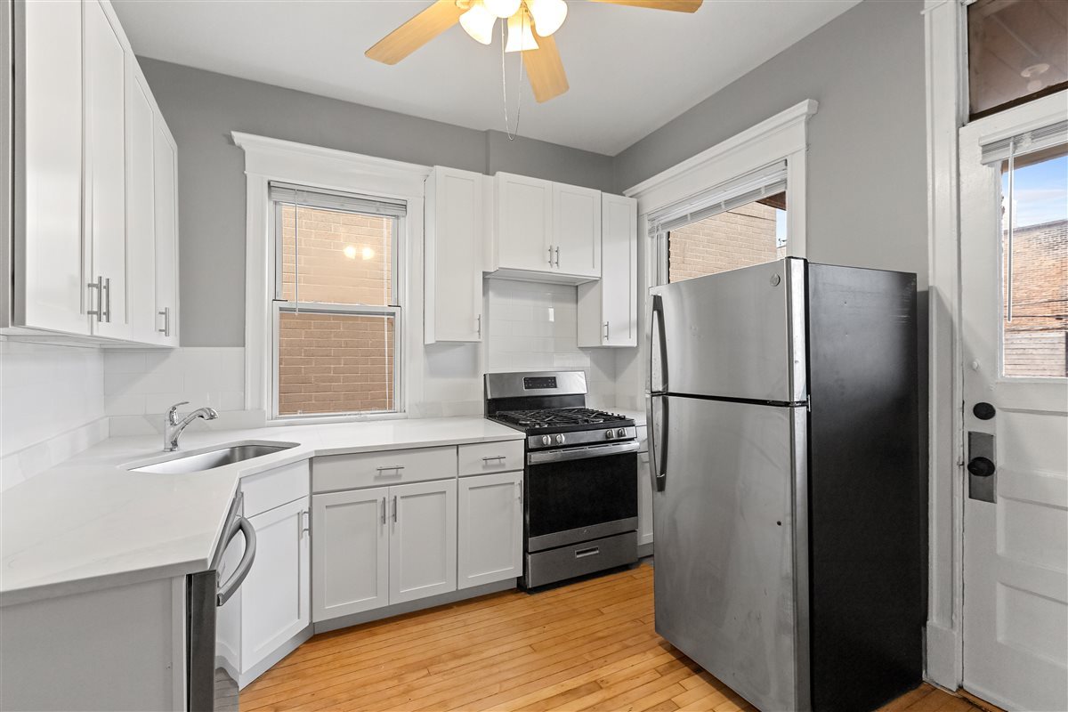 3716 North Wayne Avenue, Unit 2 Chicago, IL 60613 - Photo 2 of 17 a kitchen with a refrigerator sink and stove