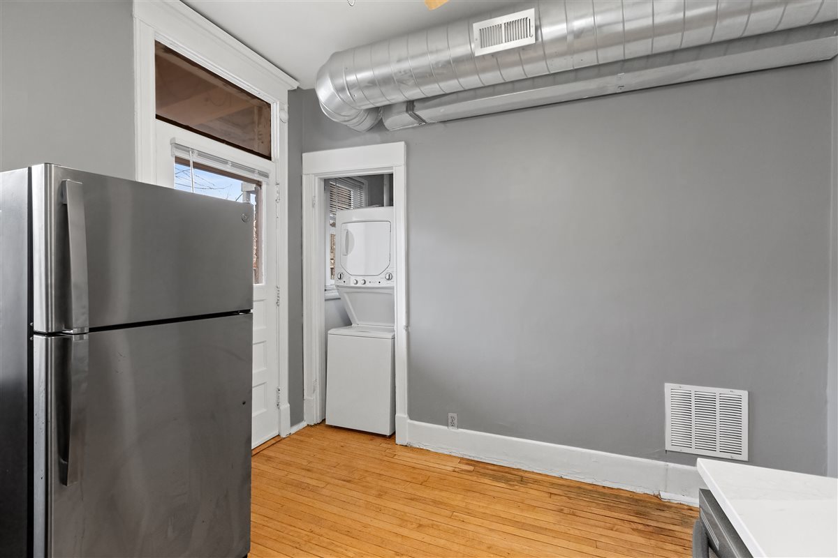 3716 North Wayne Avenue, Unit 2 Chicago, IL 60613 - Photo 3 of 17 a view of a refrigerator in kitchen and an empty room