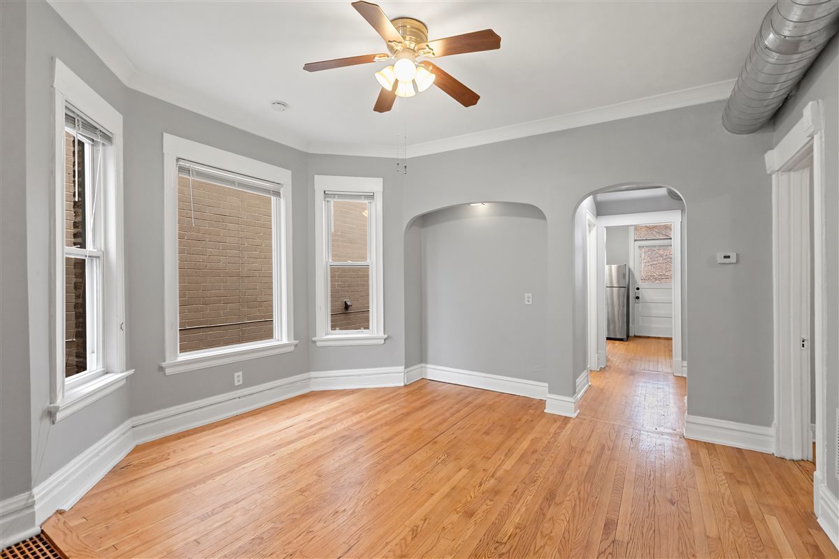 3716 North Wayne Avenue, Unit 2 Chicago, IL 60613 - Photo 4 of 17 a view of empty room with wooden floor and fan