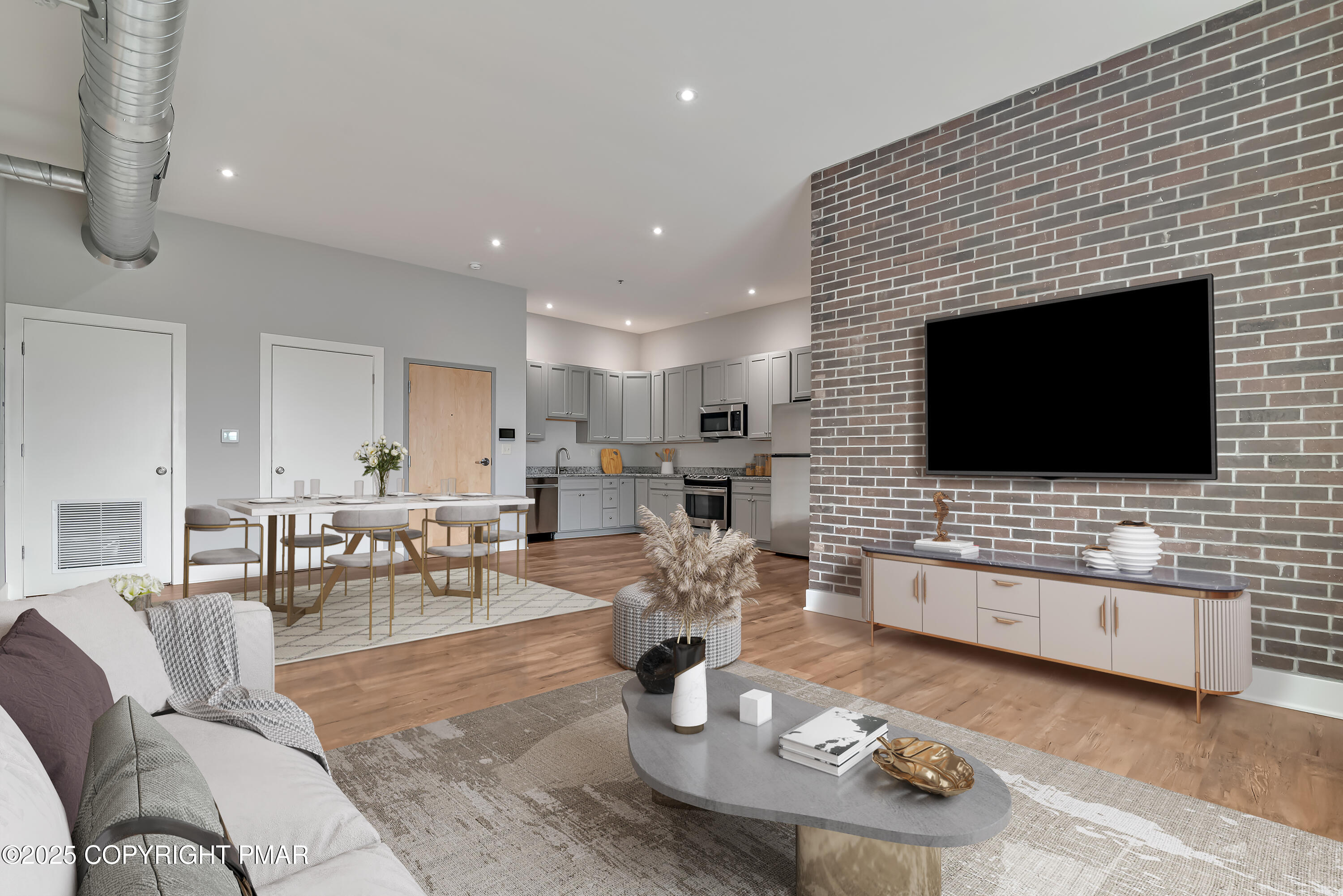 55 North Courtland Street, Unit 204 East Stroudsburg, PA 18301 - Photo 2 of 7 a living room with furniture and a flat screen tv