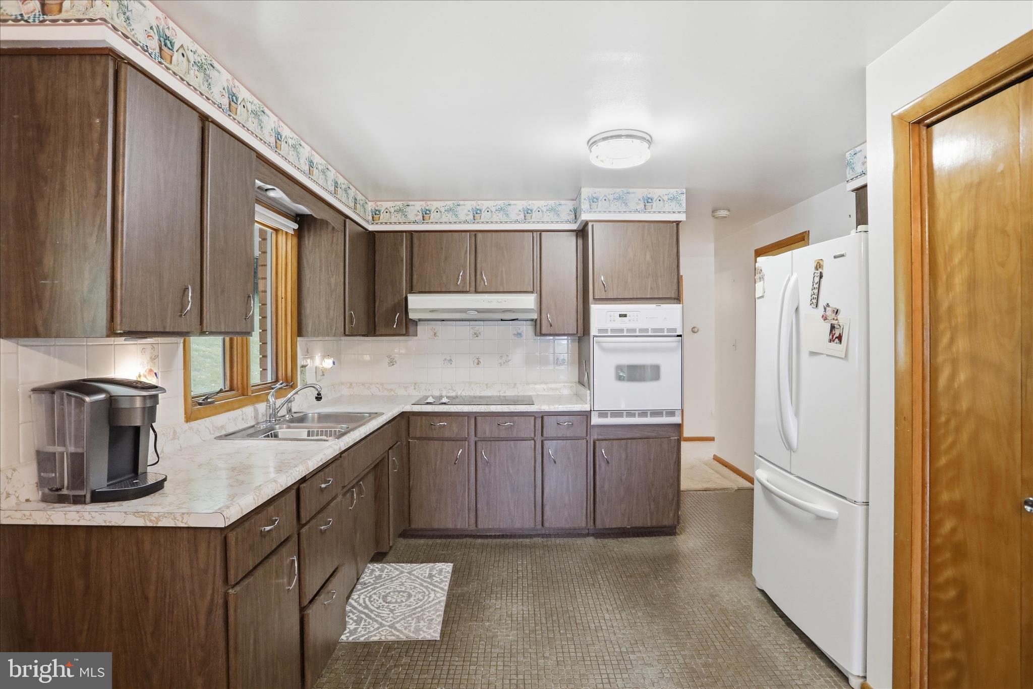 199 Buser Street Ridgeley, WV 26753 - Photo 7 of 49 a kitchen with a sink a refrigerator and cabinets