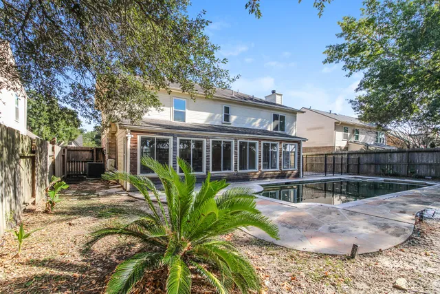 a view of a house with backyard sitting area and garden