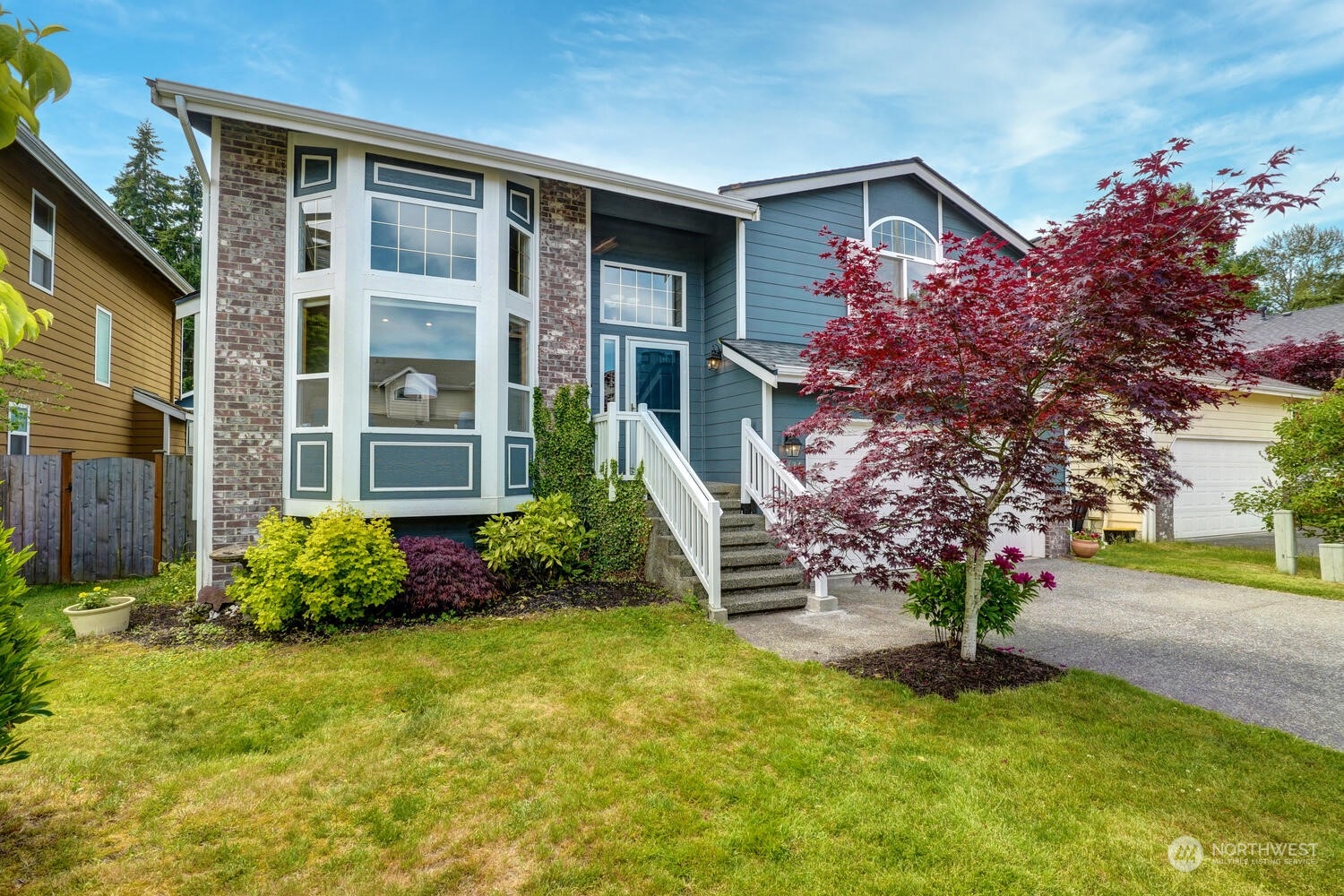 1326 238th Place Southwest Bothell, WA 98021 - Photo 2 of 34 a front view of a house with garden