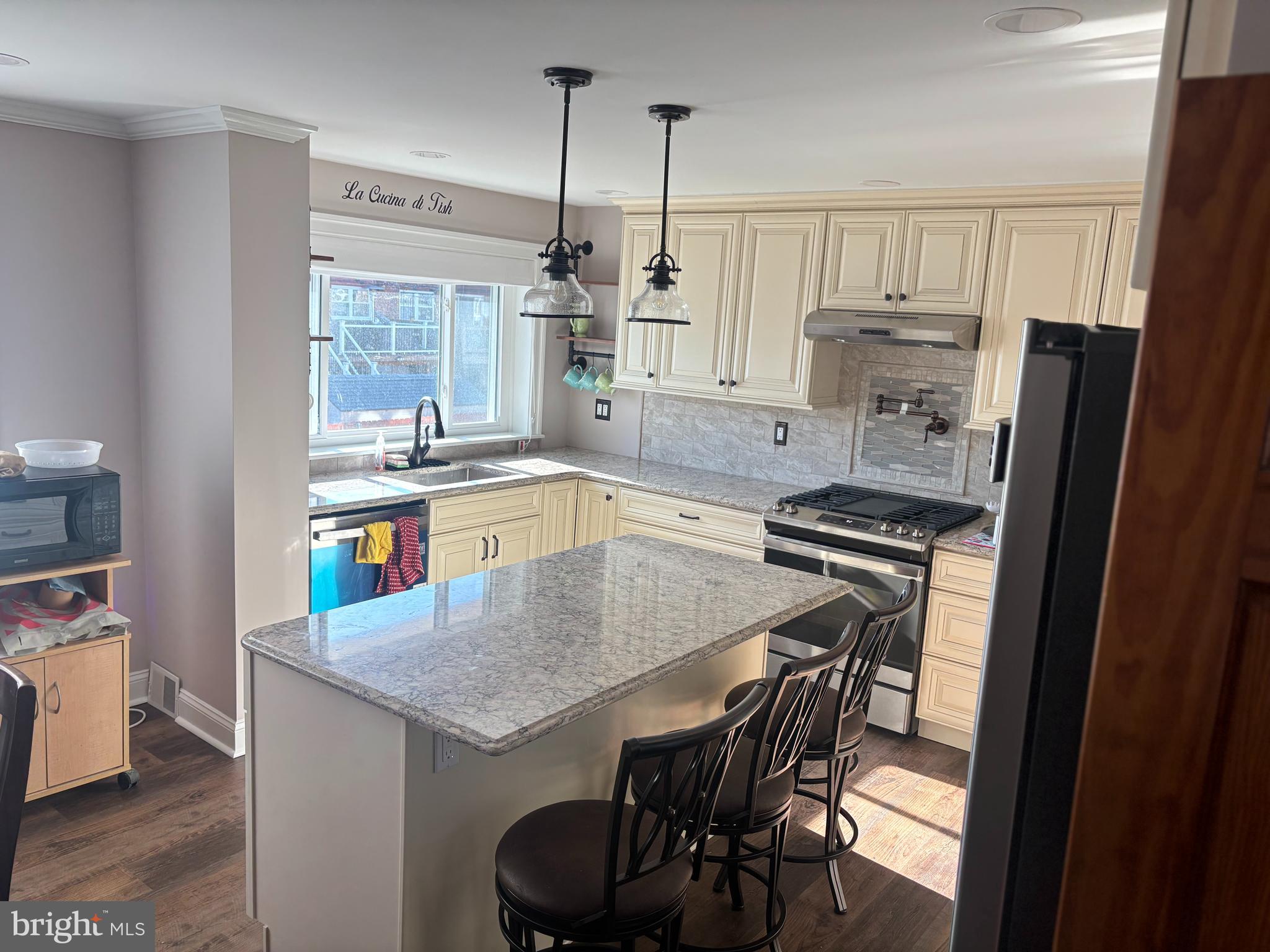 12663 Dunks Ferry Road Philadelphia, PA 19154 - Photo 7 of 22 a kitchen with a table chairs refrigerator and cabinets