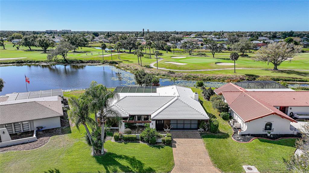 an aerial view of a house with a garden and lake view