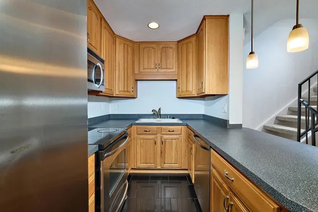 a kitchen that has a sink and a stove