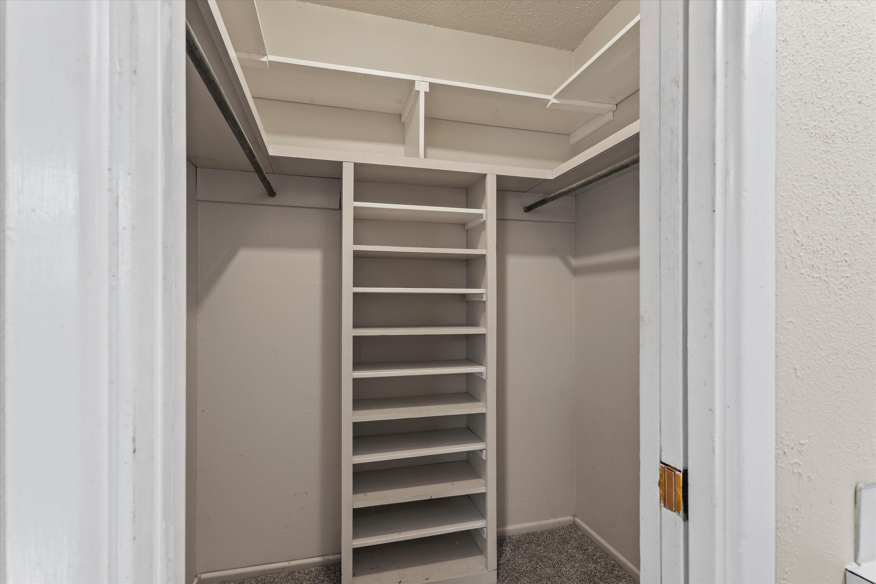 4520 54th Street Lubbock, TX 79414 - Photo 18 of 32 a view of walk in closet with empty racks