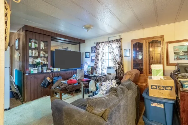 a living room with furniture and floor to ceiling window