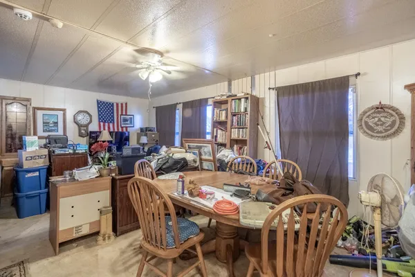 a view of a dining room with furniture and chandelier
