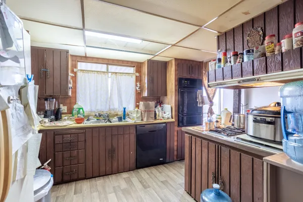a kitchen with granite countertop lots of counter top space and stainless steel appliances