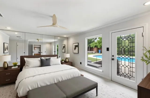 a bedroom with a large bed and a window