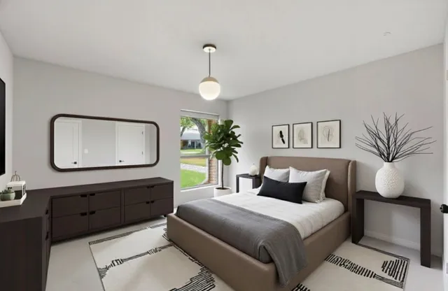 a bedroom with a large bed and a mirror on dresser