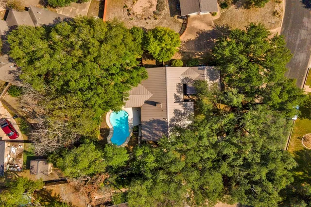 an aerial view of a house with a yard