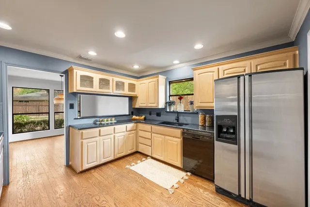a kitchen with stainless steel appliances granite countertop a refrigerator and a sink