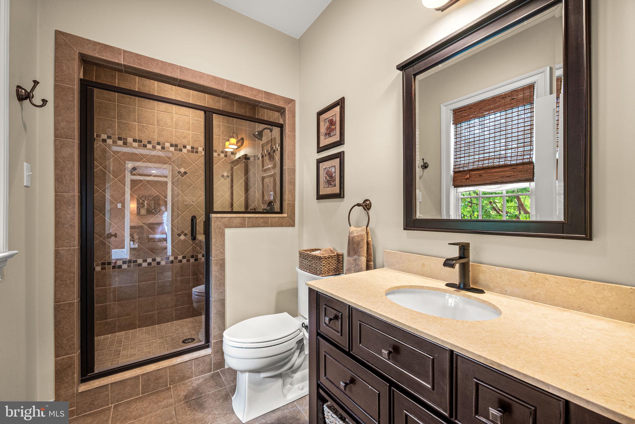 1548 Morstein Road Malvern, PA 19355 - Photo 34 of 80 a bathroom with a granite countertop sink toilet and shower