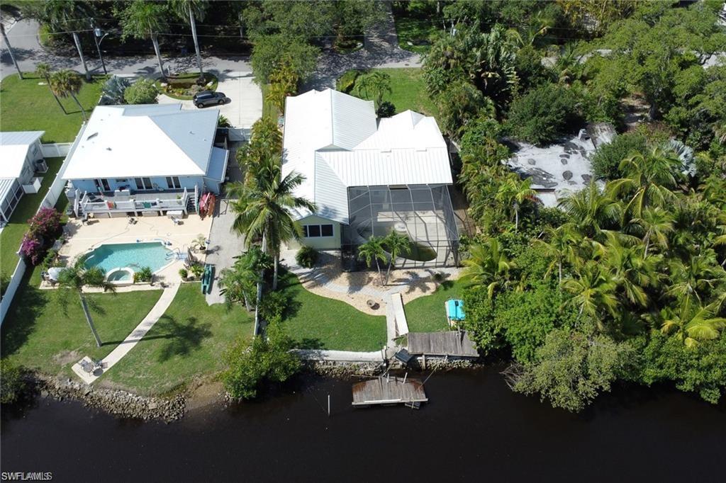 2447 Harbor Road Naples, FL 34104 - Photo 1 of 10 an aerial view of a house with a yard and lake view