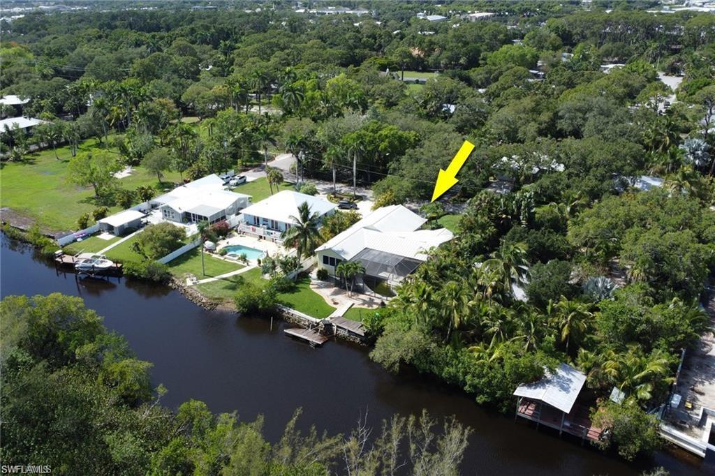 2447 Harbor Road Naples, FL 34104 - Photo 3 of 10 an aerial view of a house with a yard and lake view