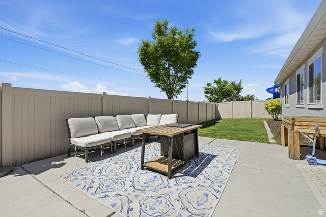 1175 Silver Hollow Road Syracuse, UT 84075 - Photo 30 of 34 Spacious patio area with concrete surfacing, a surrounding privacy fence, and a manicured lawn
