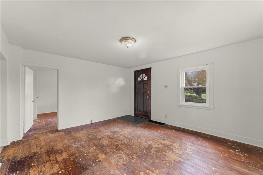 120 Grohman Road Butler, PA 16002 - Photo 5 of 28 an empty room with wooden floor and windows