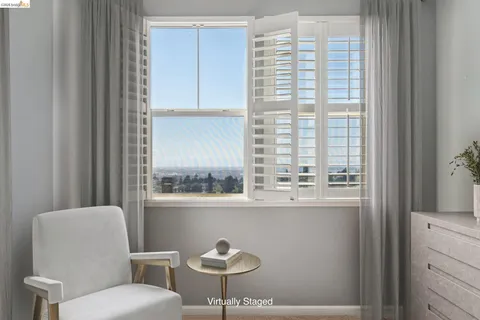 a blue chair sitting next to a window