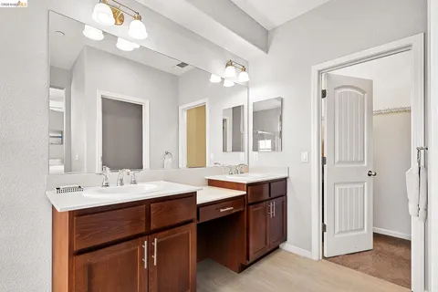 a room with a sink vanity and a mirror