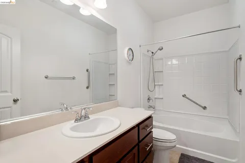 a bathroom with a sink toilet vanity and shower